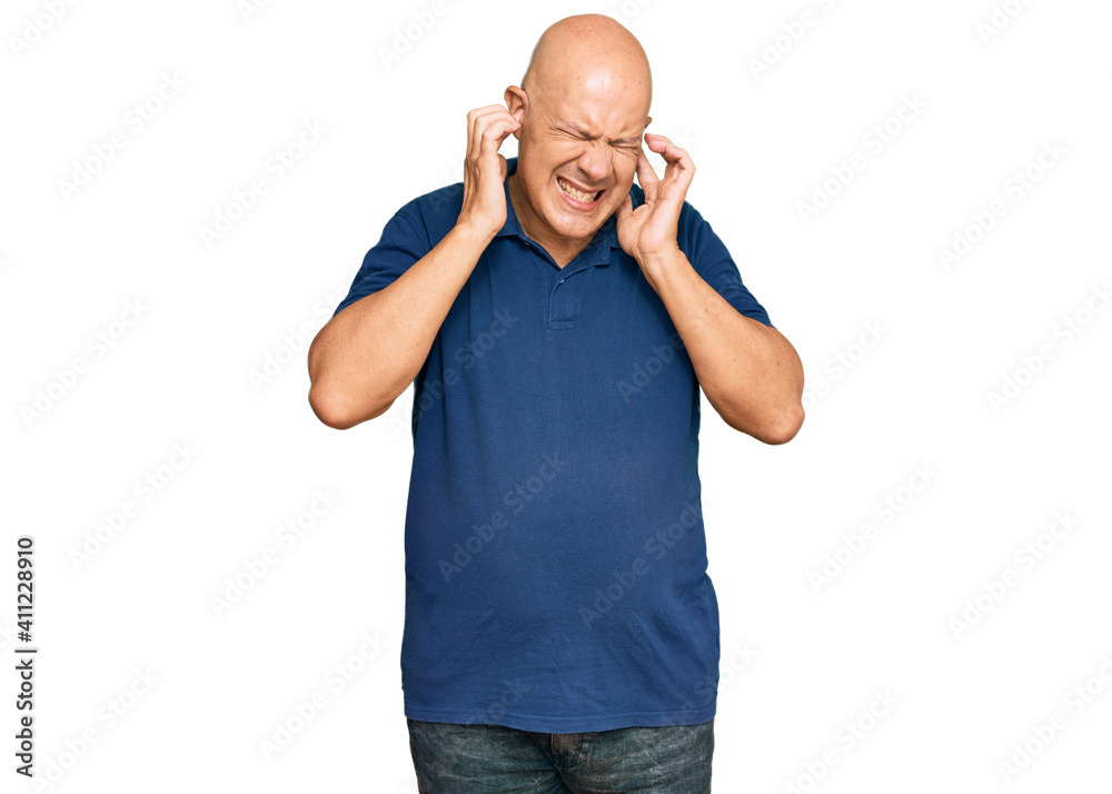 Fototapeta premium Middle age bald man wearing casual clothes covering ears with fingers with annoyed expression for the noise of loud music. deaf concept.
