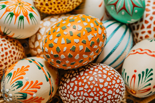 Happy Easter.Colorful hand painted decorated Easter eggs, CZ kraslice. Handmade Easter eggs in wooden basket.Spring decoration background. Festive tradition for Eastern European countries
