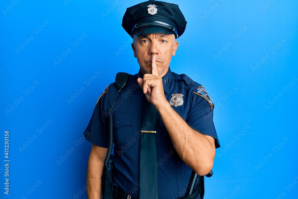 Handsome middle age mature man wearing police uniform asking to be quiet with finger on lips. silence and secret concept. Handsome middle age mature man wearing police uniform asking to be quiet with finger on lips. silence and secret concept.