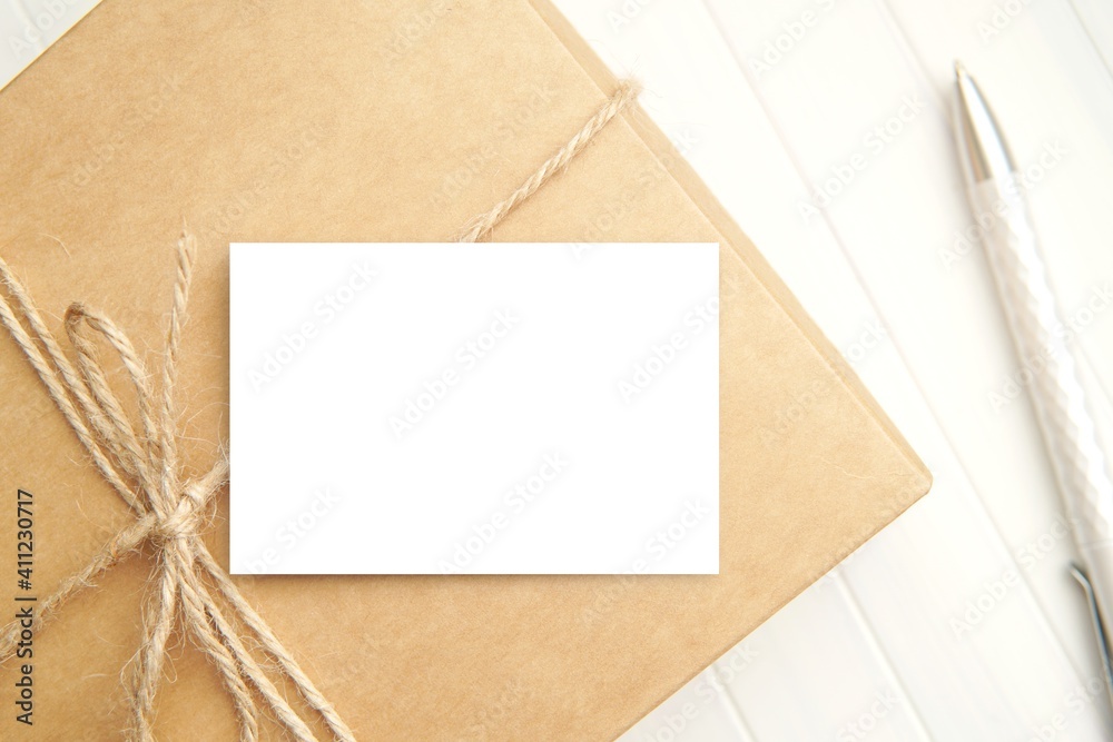 Small paper card mockup on kraft paper gift box for design presentation, business, gift, shop or Thank you card. Small paper card mockup on kraft paper gift box for design presentation, business, gift, shop or Thank you card.
