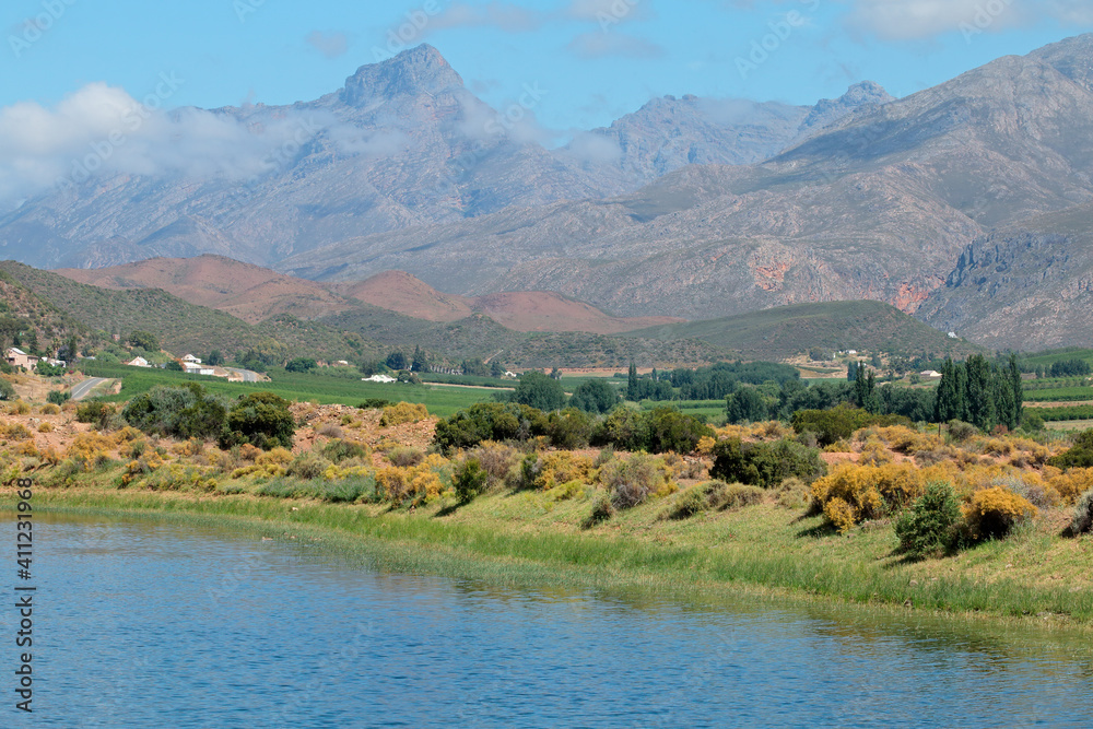 Rural landscape of farmland against a backdrop of mountains, Western Cape, South Africa.