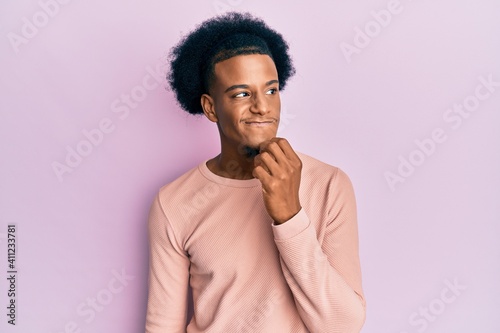 African american man with afro hair wearing casual clothes thinking concentrated about doubt with finger on chin and looking up wondering