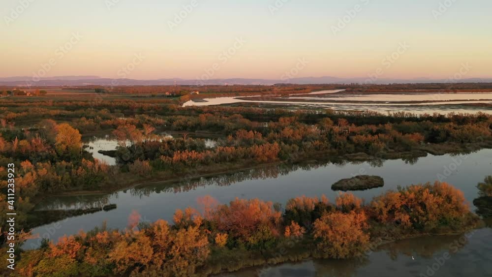view from a height of 30 meters to the bay with an interesting landscape (wetland) mountains and a house near the bay and the sky in the sunset light view from a height of 30 meters to the bay with an interesting landscape (wetland) mountains and a house near the bay and the sky in the sunset light