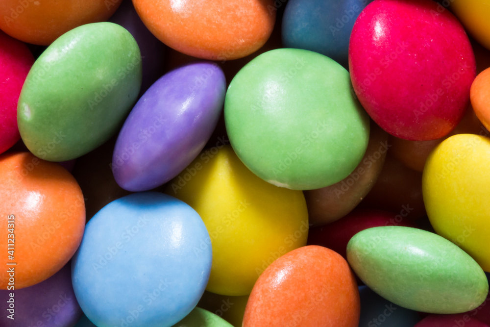 Colourful close up of sweets and candy. Coloured chocolate for desert Colourful close up of sweets and candy. Coloured chocolate for desert