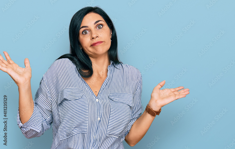 Young caucasian woman wearing casual clothes clueless and confused expression with arms and hands raised. doubt concept. Young caucasian woman wearing casual clothes clueless and confused expression with arms and hands raised. doubt concept.