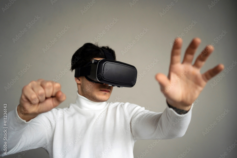 a man learns to be in a new digital game. at home alone, it is worth spending interesting time. put on a modern gadget glasses for fun. 3d virtual reality in black color. a man learns to be in a new digital game. at home alone, it is worth spending interesting time. put on a modern gadget glasses for fun. 3d virtual reality in black color.
