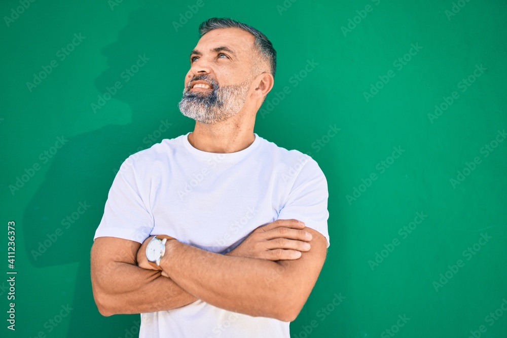 Middle age grey-haired man smiling happy standing at the city. Middle age grey-haired man smiling happy standing at the city.