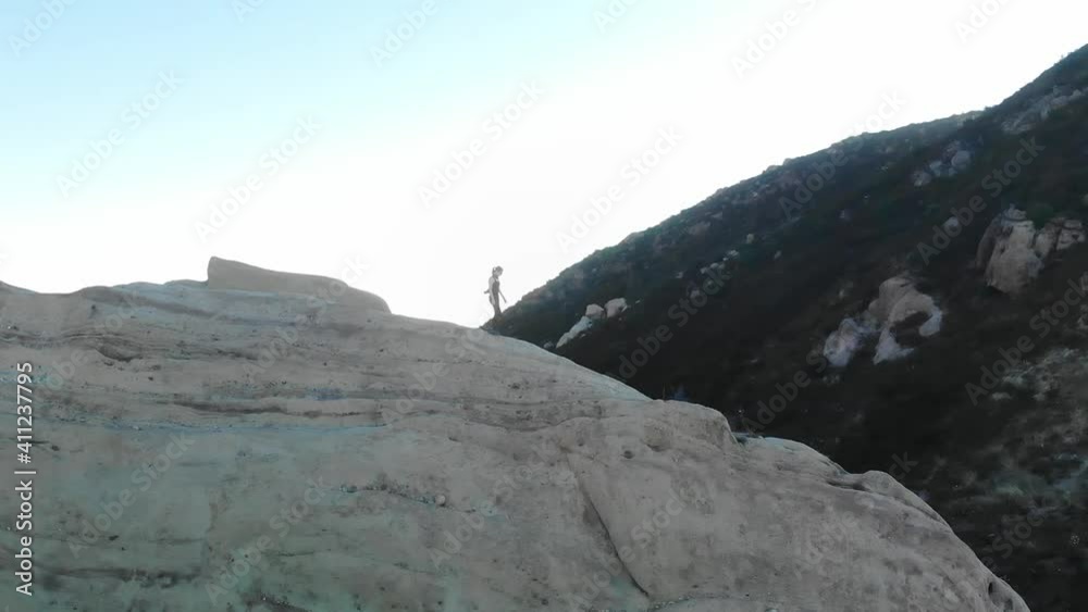 Woman hiking along a mountain ridge. Woman hiking along a mountain ridge.