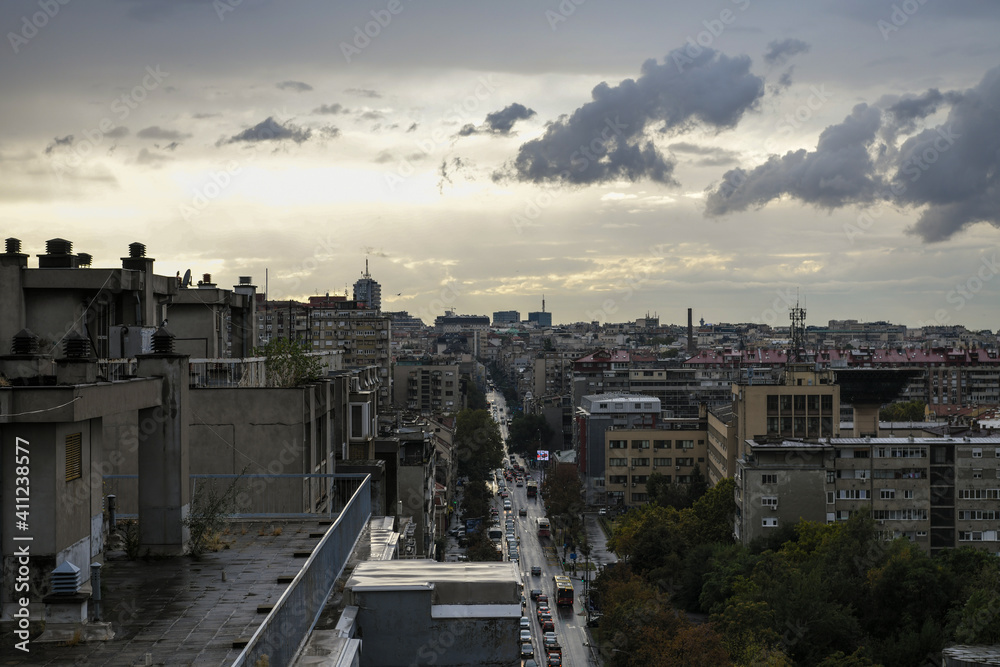 Belgrade rooftops on cloudy and rainy evening. Beautiful rooftop view of Belgrade city arhitecture and main street and traffic.