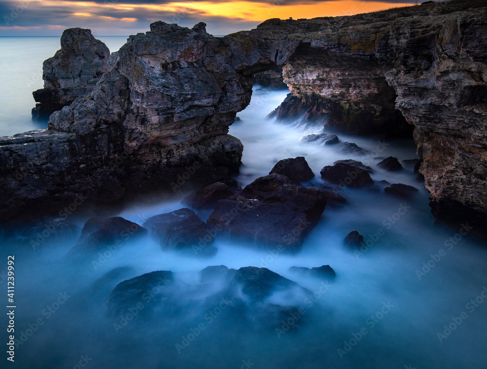 Long exposure of sea water hitting the rocky shore 