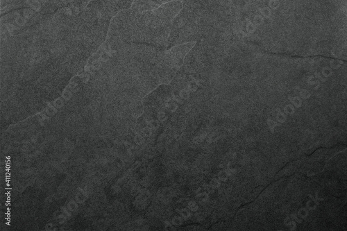 Beautiful background of a dark slate stone in close-up. Ideal for culinary or product presentation project.