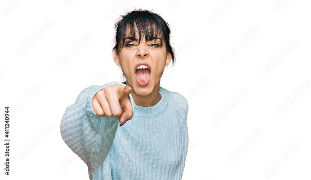 Young hispanic woman wearing casual clothes pointing displeased and frustrated to the camera, angry and furious with you Young hispanic woman wearing casual clothes pointing displeased and frustrated to the camera, angry and furious with you
