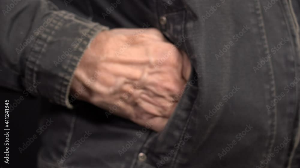 Close-up of a One Dollar in a Man's Hand in a Work Jacket. Put your Money in your Pocket. Close-up of a One Dollar in a Man's Hand in a Work Jacket. Put your Money in your Pocket.