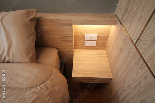 Close up grey bed sheet in bedroom, cozy interior decor with earth tone, Bed top view with wooden floor