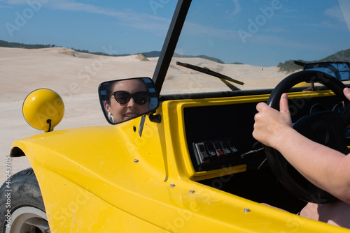 Woman driving on sand dunes