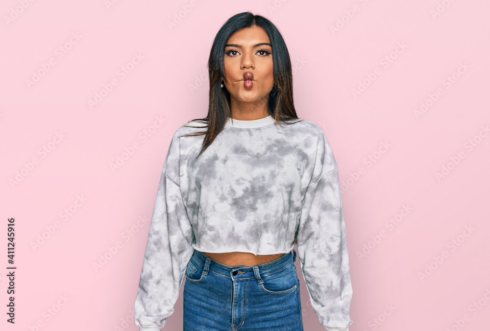 Young latin transsexual transgender woman wearing casual clothes making fish face with lips, crazy and comical gesture. funny expression. Young latin transsexual transgender woman wearing casual clothes making fish face with lips, crazy and comical gesture. funny expression.