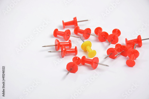 Isolated of yellow thumbtack with red thumbtack on white background