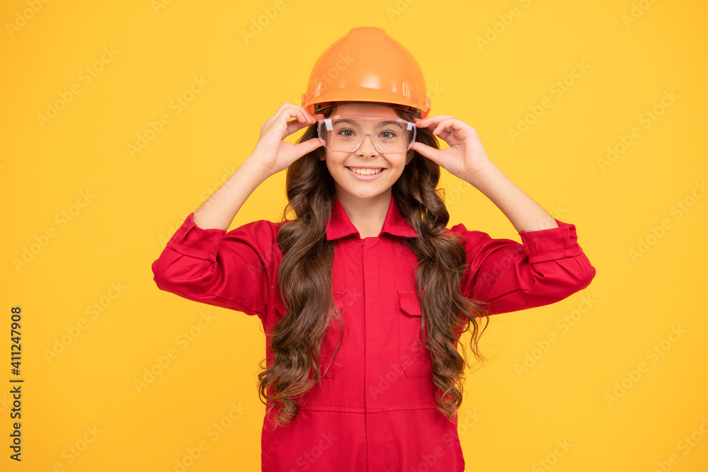 happy teenager girl in protective eyeglasses and helmet, engineer