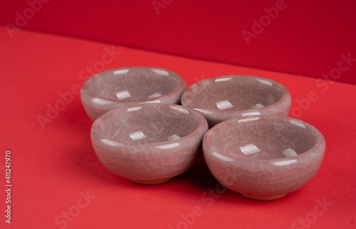 Chinese teapot and teacup with red backgroundnd photo