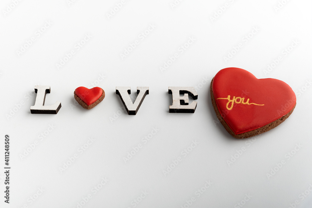 Inscription Love on white background with heart instead of letter O and big red heart.