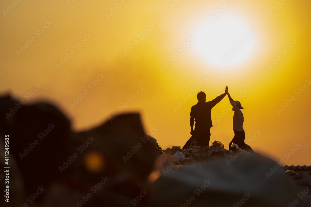 Fototapeta premium The success of the poor and happy In the garbage collection for sale People living in the heap walk to collect recyclable waste to sell to World Environment Day poverty concept.