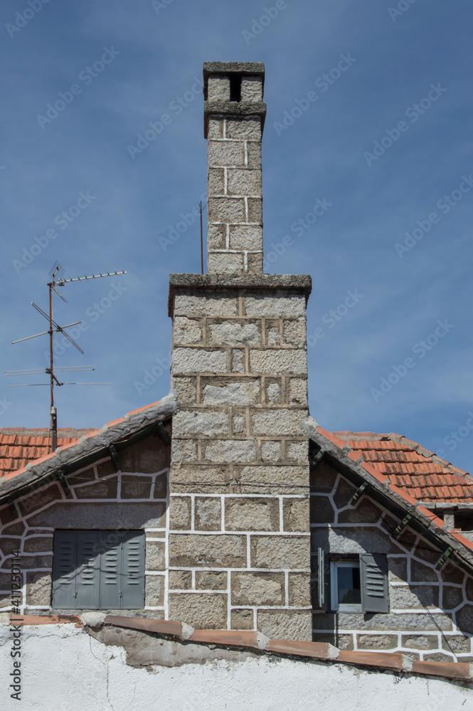 stone wall of house facade with chimneys