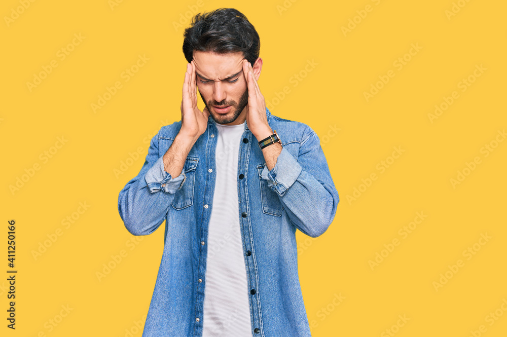 Young hispanic man wearing casual clothes with hand on head, headache because stress. suffering migraine. Young hispanic man wearing casual clothes with hand on head, headache because stress. suffering migraine.