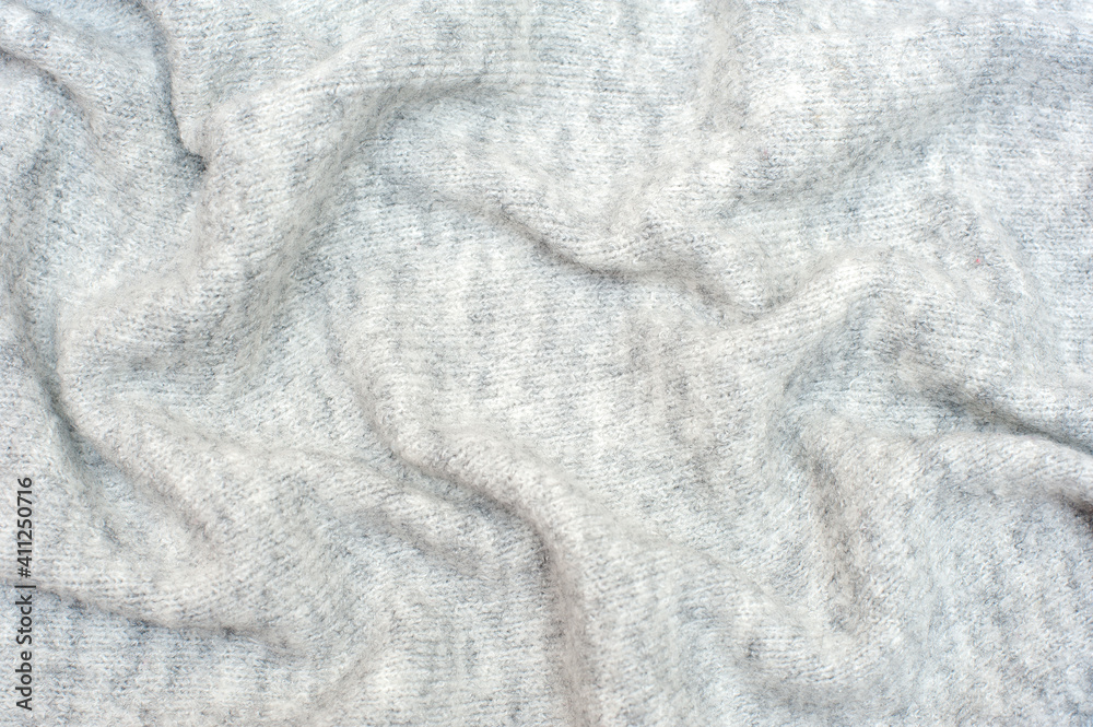 Naklejka premium Knitted gray background. Textures for backgrounds. 