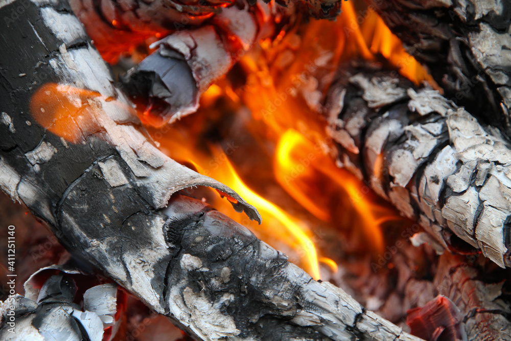 Glowing embers in hot red color, abstract background. The hot embers of burning wood log fire. Firewood burning on grill. Texture fire bonfire embers. Glowing embers in hot red color, abstract background. The hot embers of burning wood log fire. Firewood burning on grill. Texture fire bonfire embers.