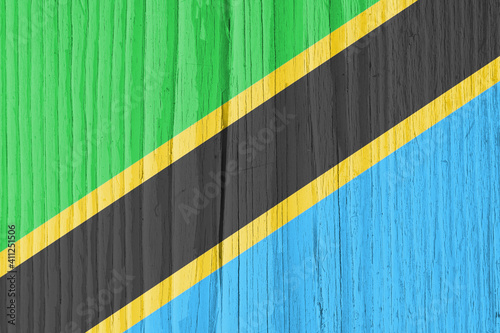 The flag of Tanzania on dry wooden surface, cracked with age. Background, wallpaper or backdrop with Tanzanian national symbol