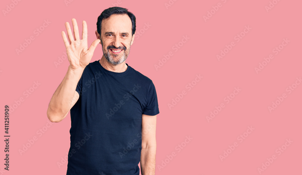 Middle age handsome man wearing casual t-shirt showing and pointing up with fingers number five while smiling confident and happy. Middle age handsome man wearing casual t-shirt showing and pointing up with fingers number five while smiling confident and happy.