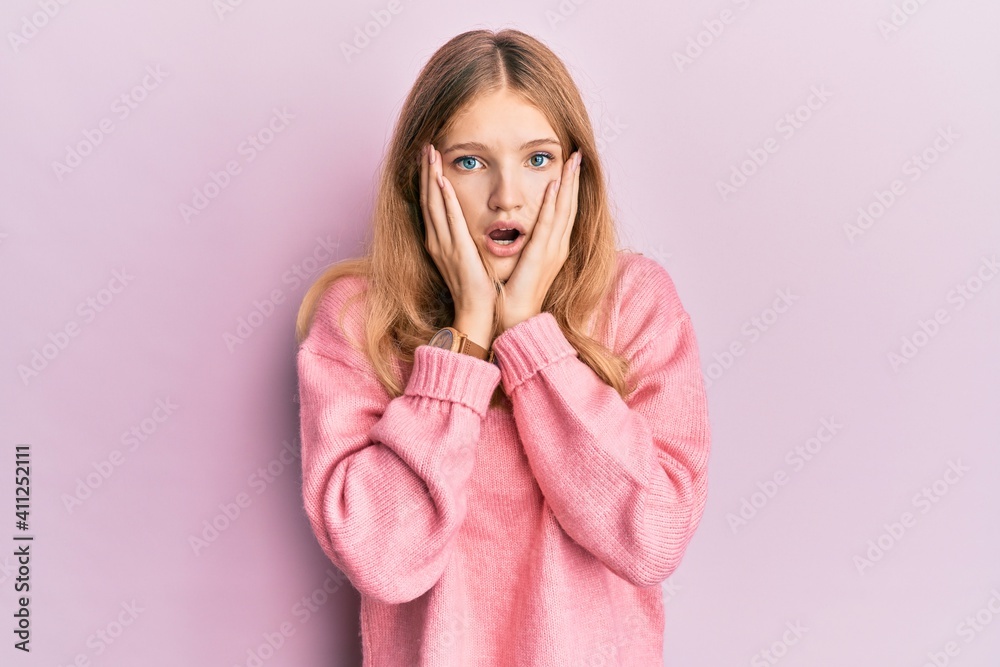 Beautiful young caucasian girl wearing casual clothes afraid and shocked, surprise and amazed expression with hands on face Beautiful young caucasian girl wearing casual clothes afraid and shocked, surprise and amazed expression with hands on face