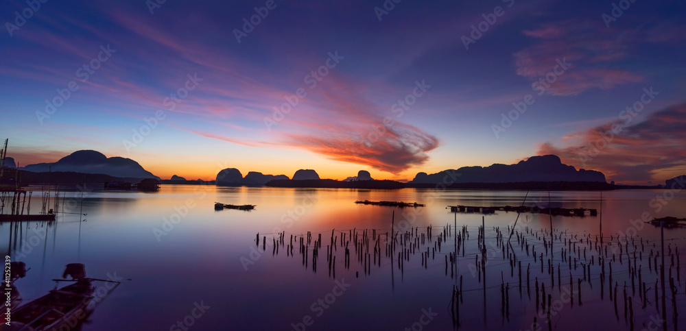 Beautiful sunset or sunrise with dramatic colorful sky clouds over calm ...