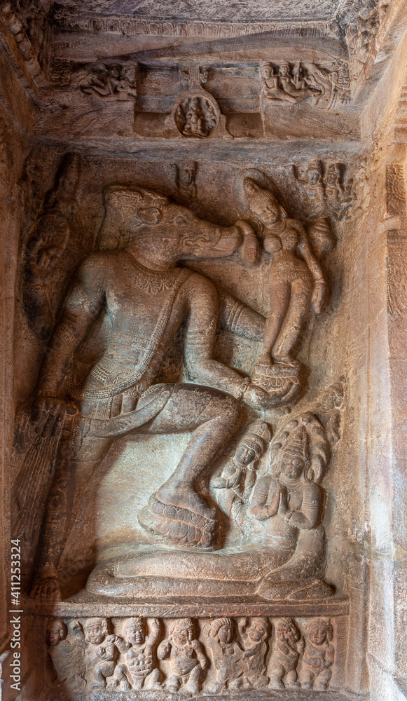 Badami, Karnataka, India - November 7, 2013: Cave temples above Agasthya Lake. Brown stone sculpture featuring Vishnu as Varaha rescuing Earth as Bhudevi.