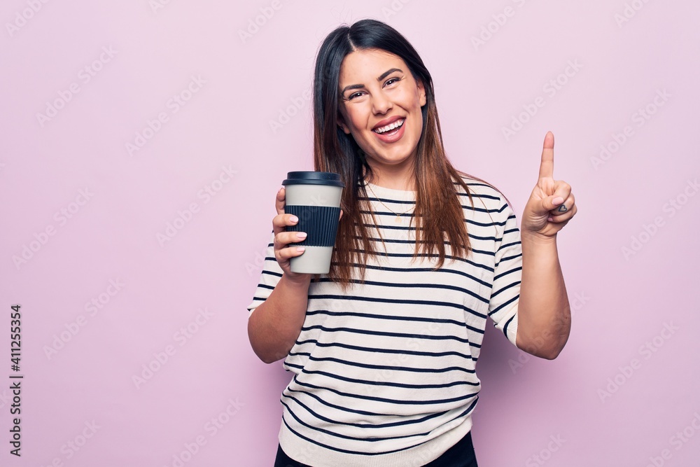 Young beautiful brunette woman drinking cup of takeaway coffee over isolated pink background smiling with an idea or question pointing finger with happy face, number one Young beautiful brunette woman drinking cup of takeaway coffee over isolated pink background smiling with an idea or question pointing finger with happy face, number one