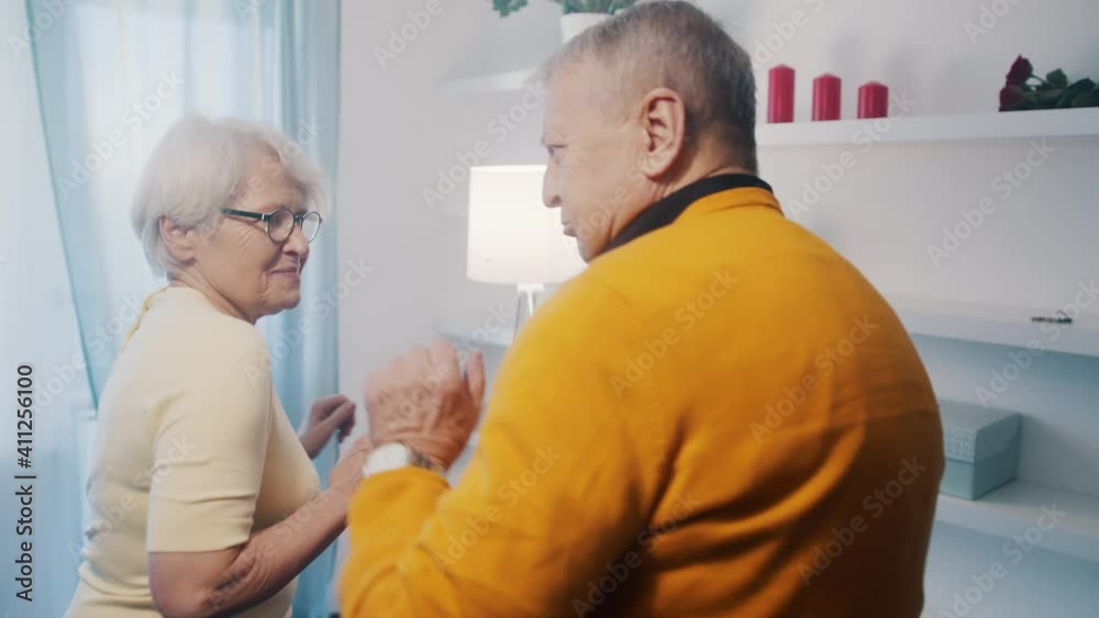 Happy elderly couple dancing at home with disco lights. Love and dating at old age. High quality 4k footage Happy elderly couple dancing at home with disco lights. Love and dating at old age. High quality 4k footage