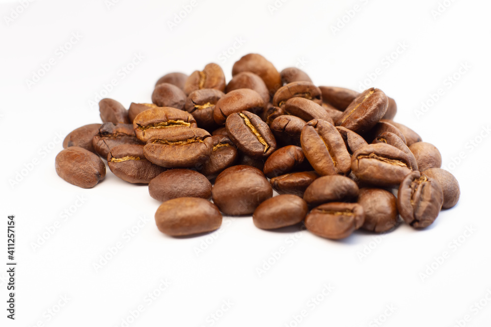 Roasted coffee beans heap isolated on white background can be used as background Roasted coffee beans heap isolated on white background can be used as background