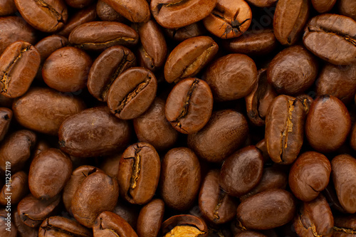 Roasted coffee beans heap isolated on white background can be used as background