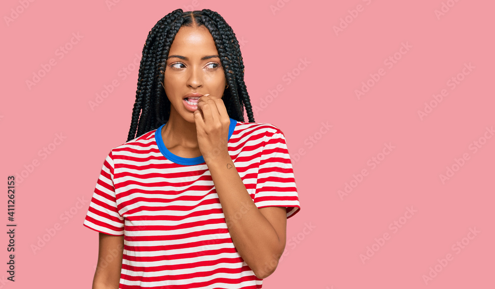 Beautiful hispanic woman wearing casual clothes looking stressed and nervous with hands on mouth biting nails. anxiety problem. Beautiful hispanic woman wearing casual clothes looking stressed and nervous with hands on mouth biting nails. anxiety problem.