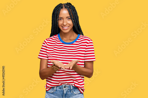 Beautiful hispanic woman wearing casual clothes smiling with hands palms together receiving or giving gesture. hold and protection
