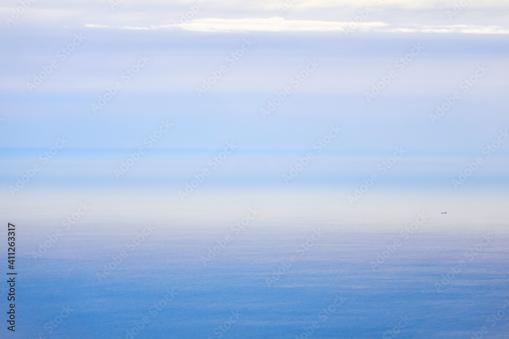 background, waterscape - the morning sea merges with the sky