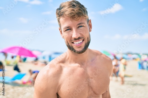 Handsome fitness caucasian man at the beach on a sunny day