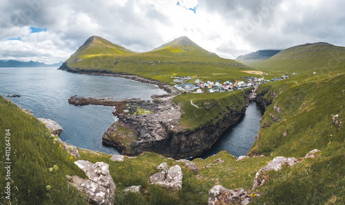 Faroe islands village of Gjogv or Gjov in Danish. Sea-filled gorge on the northeast tip of the island of Eysturoy, in the Faroe Islands.