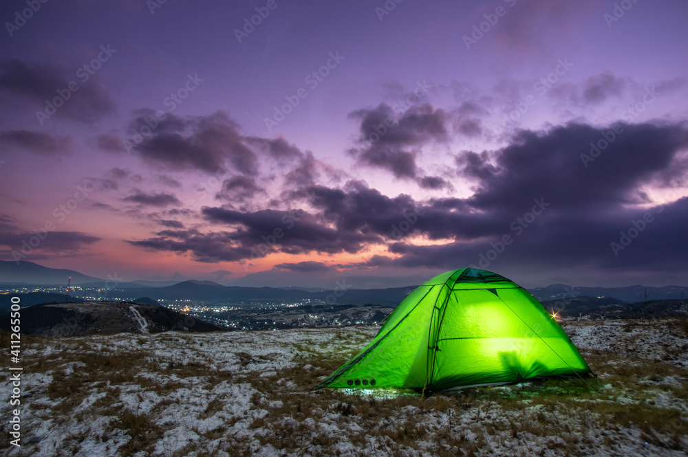 Tent on the background of a winter sunset in the mountains Tent on the background of a winter sunset in the mountains