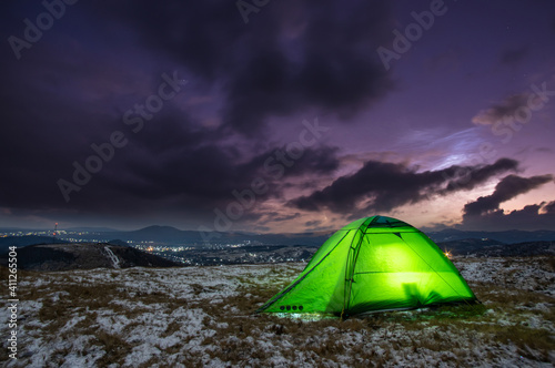 Tent on the background of a winter sunset in the mountains © onyx124