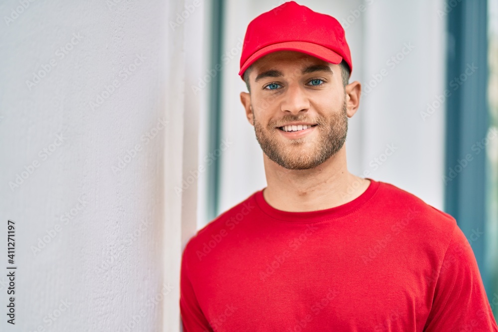 Young caucasian deliveryman smiling happy standing at the city. Young caucasian deliveryman smiling happy standing at the city.