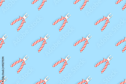 Pliers seamless pattern. Metal pliers with rubber striped grips. Background made of tools. 