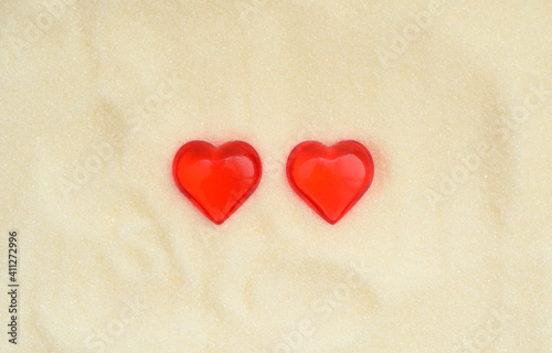 Two love valentine day hearts on sweet sugar background.