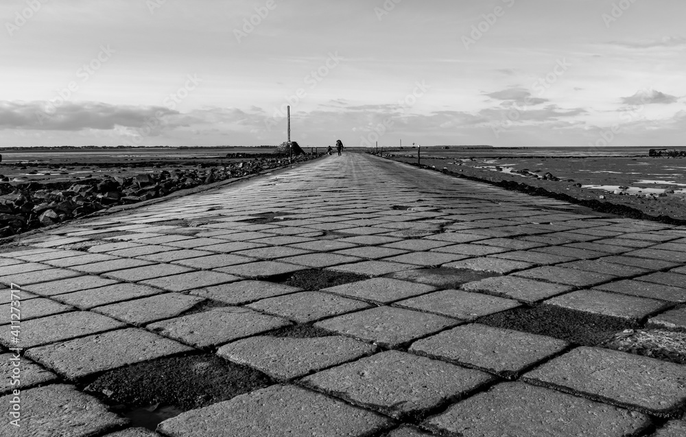 Vendée, France: black and white photo of the cobblestones of the Passage du Gois, to reach the island of Noirmoutier, a submersible road, January 2021.