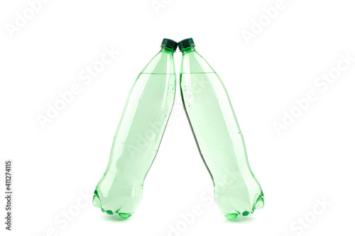 Two plastic transparent bottles with mineral water on a white background. Copy space.